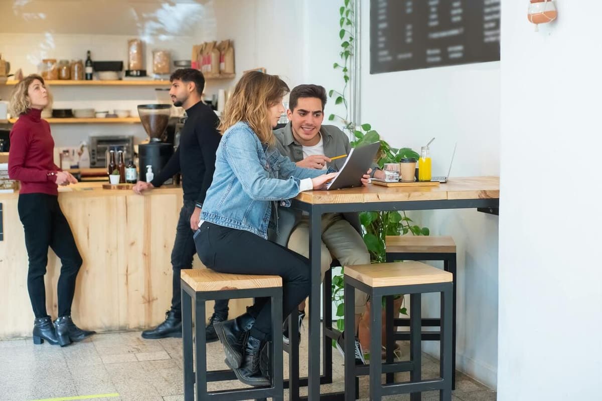 Business meeting at a cafe showing Go Solutions team members collaborating